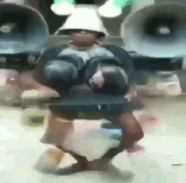 a man in a samurai costume is dancing in front of a speaker .
