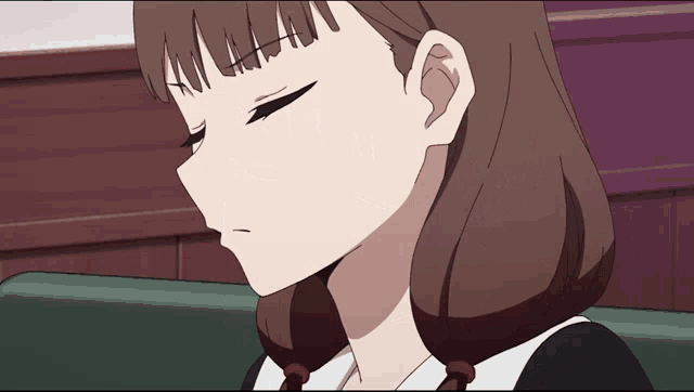 a close up of a girl 's face with a sad look on her face