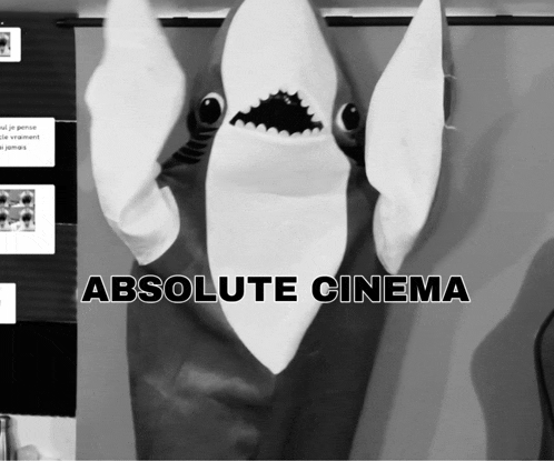a black and white photo of a stuffed shark with absolute cinema written on the bottom