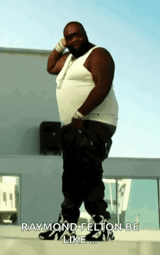 a fat man in a white tank top and black pants is standing on a ledge and says raymond felton be like