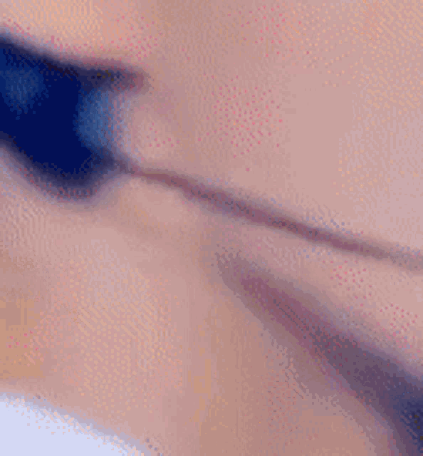 a close up of a person 's face with a blurred background and a few dots on it .