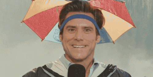 a man wearing a headband and an umbrella is smiling
