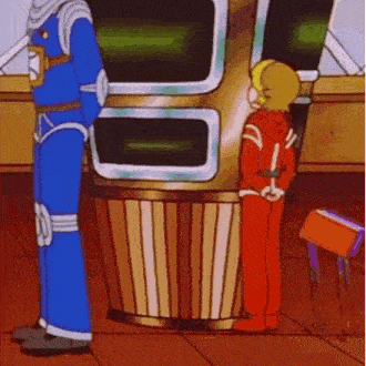 two cartoon characters are standing next to each other in front of a large machine .
