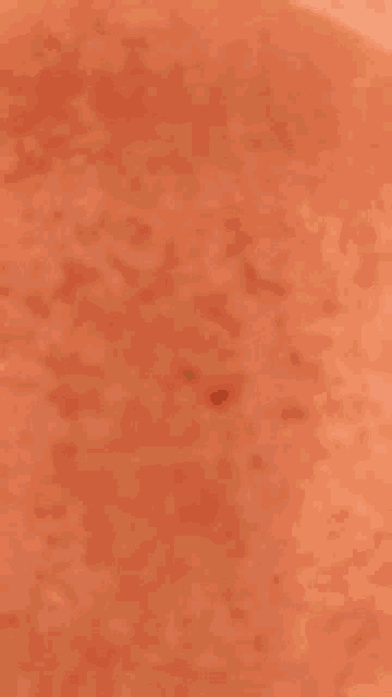 a close up of a glass filled with a pink liquid