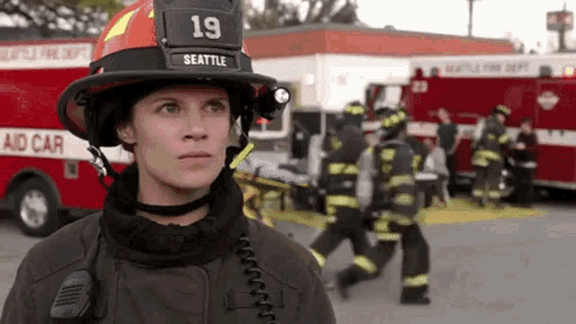 a woman wearing a helmet that says seattle on it