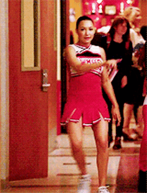 a cheerleader wearing a uniform that says wmhs