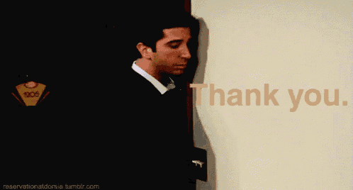 a man leaning against a wall with the words thank you written on it