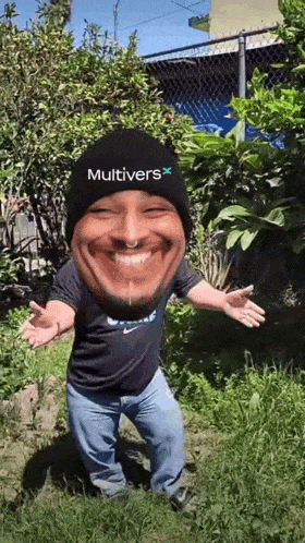a man wearing a hat with the word multivers on it is standing in the grass .