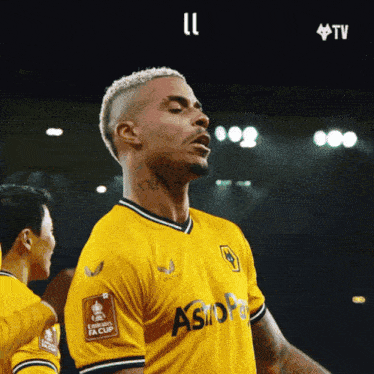 a soccer player wearing a yellow jersey that says ' astra ' on it