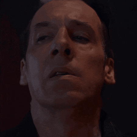 a close up of a man 's face with a serious look on his face