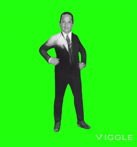 a man in a suit and tie is dancing on a green screen ..