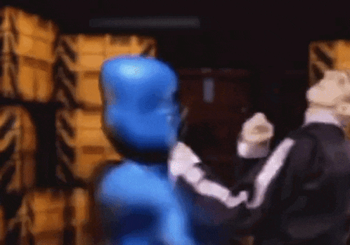 a man in a blue suit is standing next to another man in a black suit .