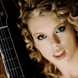 a close up of a woman 's face and a guitar