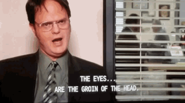 a man in a suit and tie is talking about the eyes and the groin of the head .