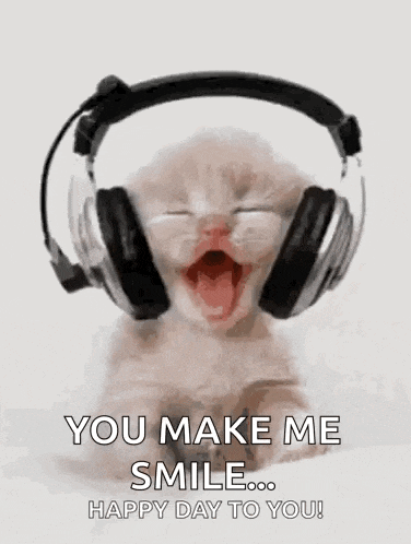 a kitten wearing headphones with its mouth open and a happy day to you .