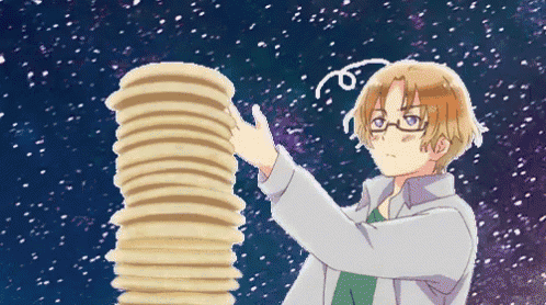 a man with glasses holds a stack of pancakes in his hand