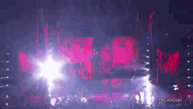 a crowd of people are gathered in front of a stage with oklahoma written on the bottom
