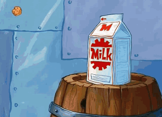 a carton of milk is on a wooden barrel