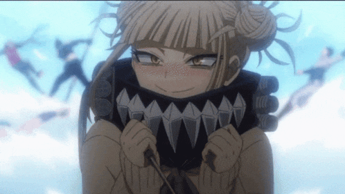a girl with shark teeth on her face is looking at the camera .