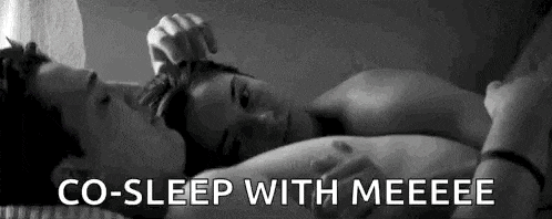 a man and a woman are laying on a bed with the words `` co-sleep with meeeee '' written above them .