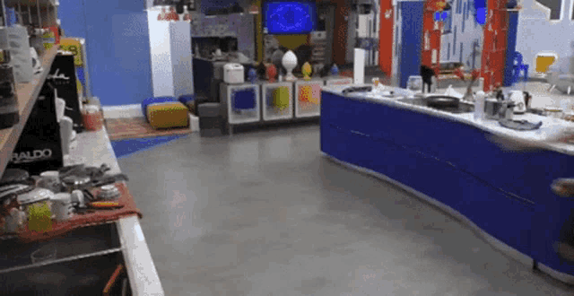 a kitchen with blue cabinets and a aldo sign