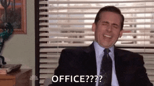 a man in a suit and tie is sitting in front of a window in an office .