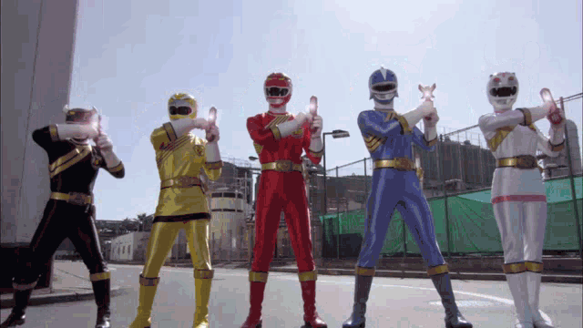 a group of power rangers are standing in a row