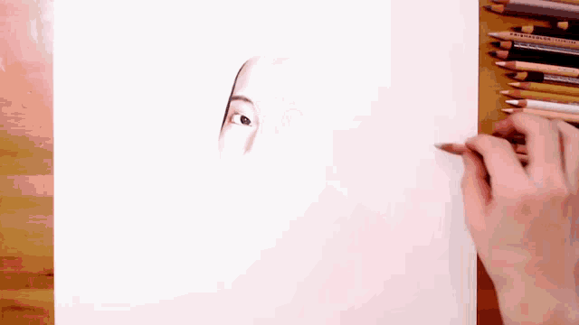 a person drawing a face with a prismacolor colored pencil
