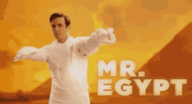 a man standing in front of a pyramid with the words mr. egypt written on the bottom