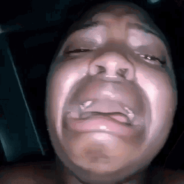 a close up of a person 's face with their mouth open .