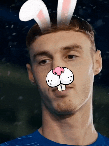a man wearing bunny ears on his head looks at the camera