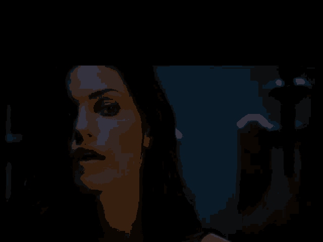 a close up of a woman 's face with her mouth open