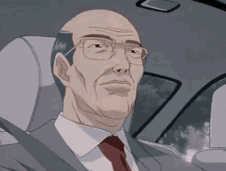 a bald man wearing glasses and a suit is sitting in the driver 's seat of a car .