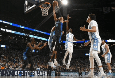 a basketball game is being played in front of a banner that says " life a tournament "