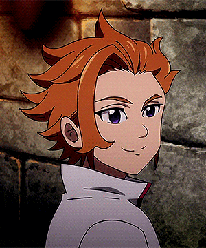a close up of a cartoon character 's face with a brick wall in the background