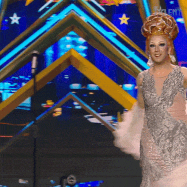 a woman with a crown on her head stands in front of a microphone with the word talent on the screen