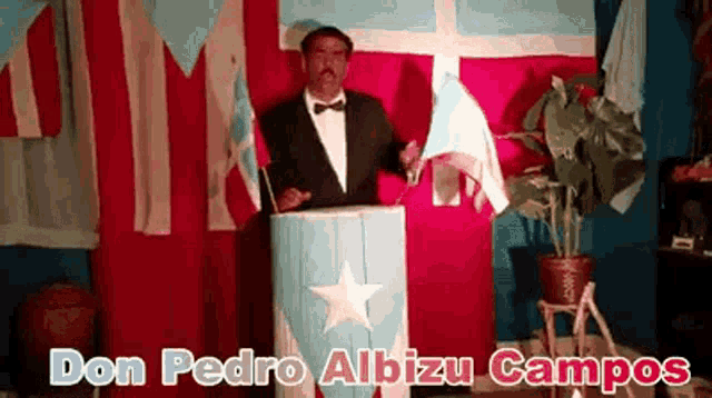 a man in a tuxedo stands behind a podium with the name don pedro albizu campos written on it