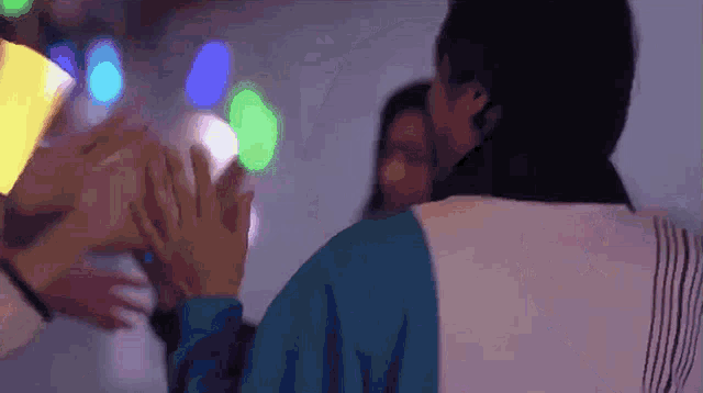 a group of people are putting their hands together in a circle