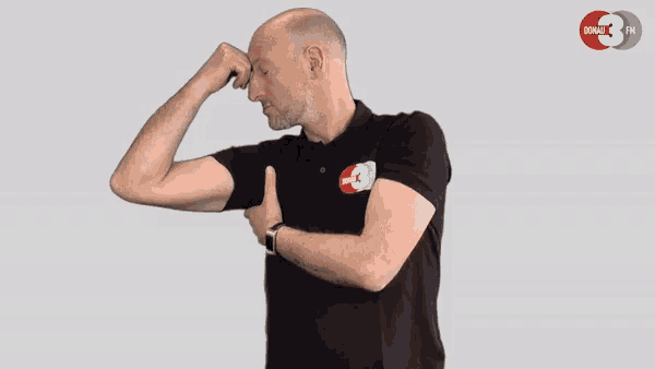 a man wearing a black polo shirt with a donate fm logo