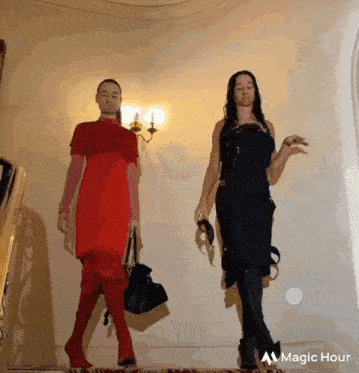 a woman in a red dress and a woman in a black dress are walking down a hallway ..