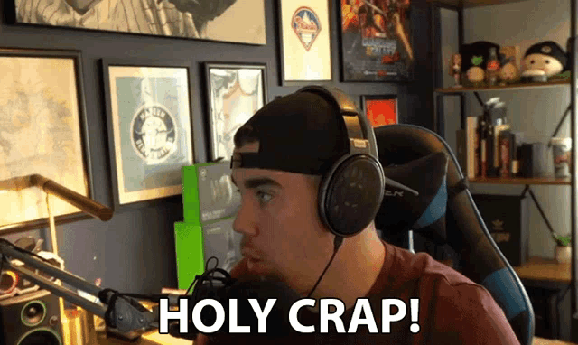 a man wearing headphones says holy crap while sitting in a chair