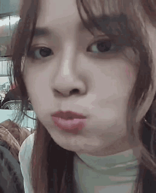 a close up of a woman 's face with her mouth open