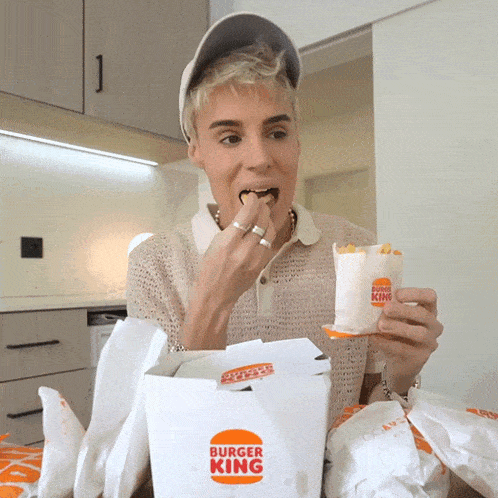 a man is eating a burger king sandwich