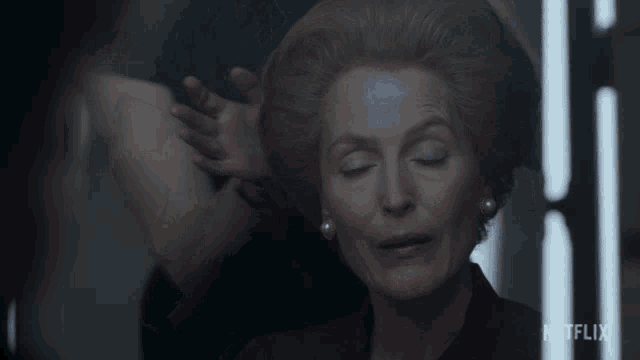 a woman is getting her hair done in a netflix video