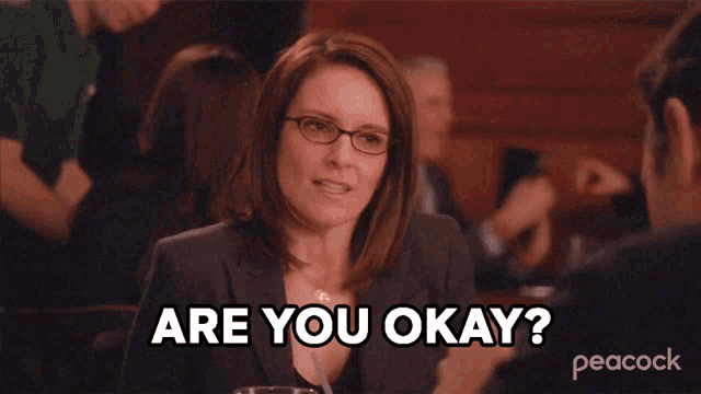 a woman with glasses says " are you okay " in front of a peacock logo