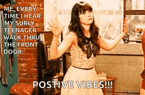 a woman in a white dress is standing in front of a brick wall with a caption that says positive vibes