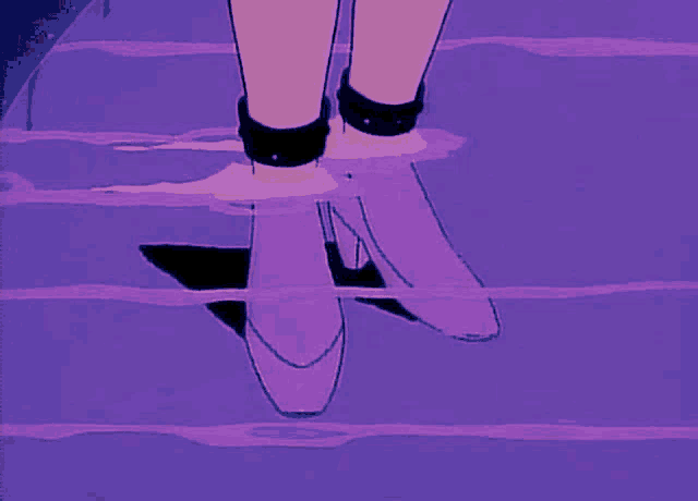 a person 's feet are floating in a purple water