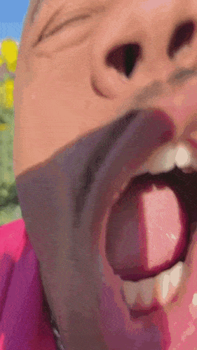 a close up of a man 's face with his tongue out