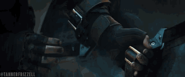 a close up of a person holding another person 's hand .