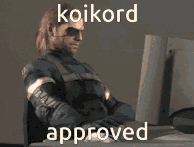a man is sitting in front of a computer with the words koikord approved on the bottom